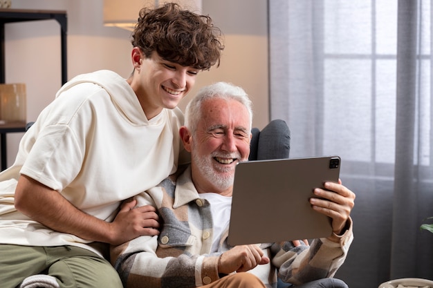 Criança sorridente de tiro médio e homem com tablet