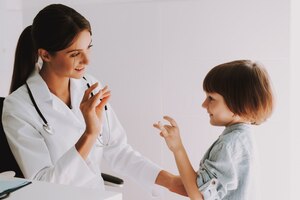 Foto criança surda fala linguagem gestual com pediatra.