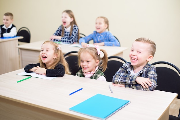 Foto crianças bonitas são alunos juntos em uma sala de aula na escola recebem a educação