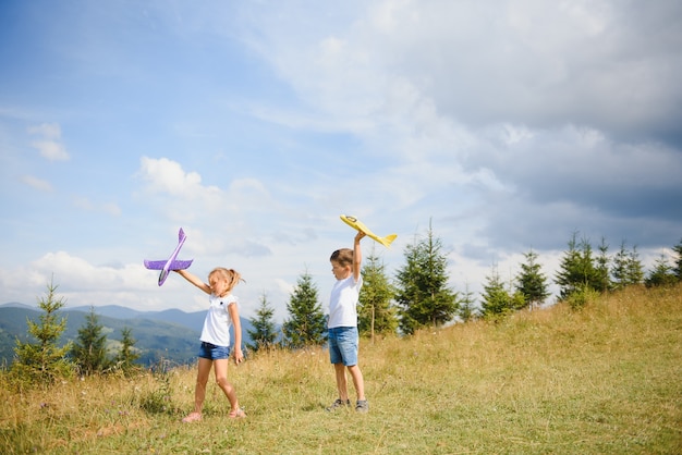 Crianças brincando com aviões de brinquedo