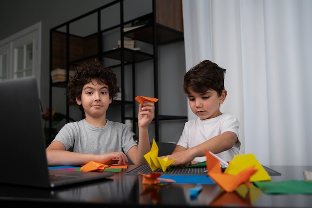 Crianças brincando com papel de origami