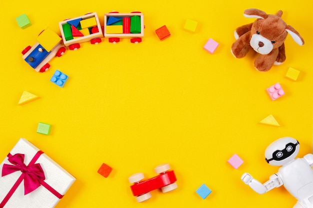 Crianças brinquedo bebê ursinho de pelúcia brinquedo trem presente caixa de presente e outros brinquedos em fundo amarelo