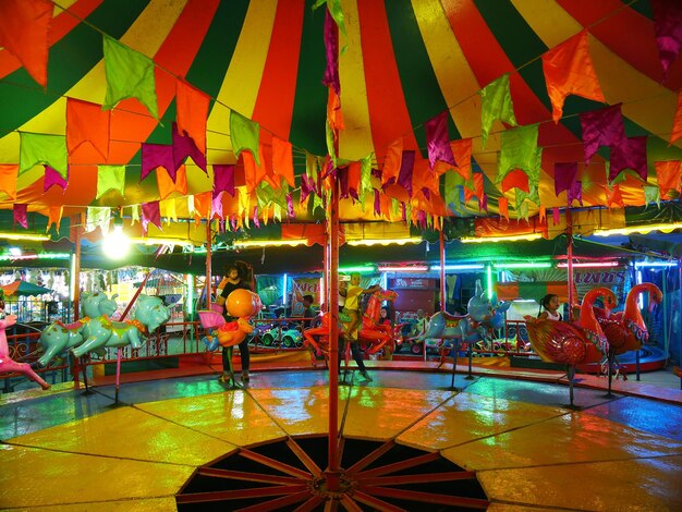 Foto crianças em um parque de diversões durante a noite