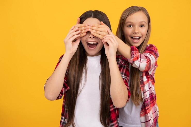 Foto crianças felizes em camisa xadrez casual se divertindo fechando os olhos no fundo amarelo adivinha quem