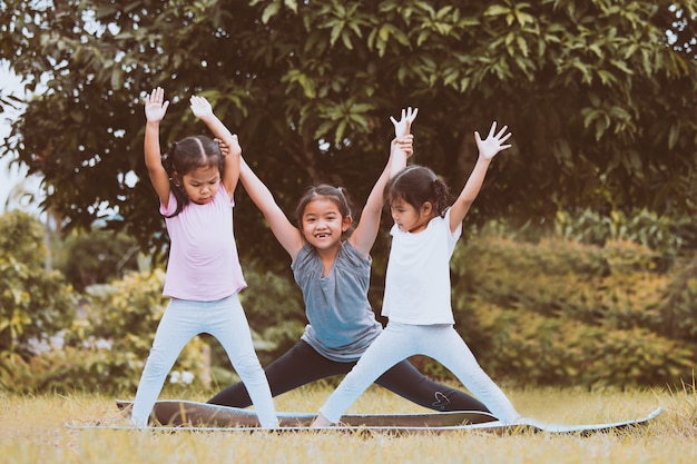 Foto crianças felizes fazendo exercício juntos no parque