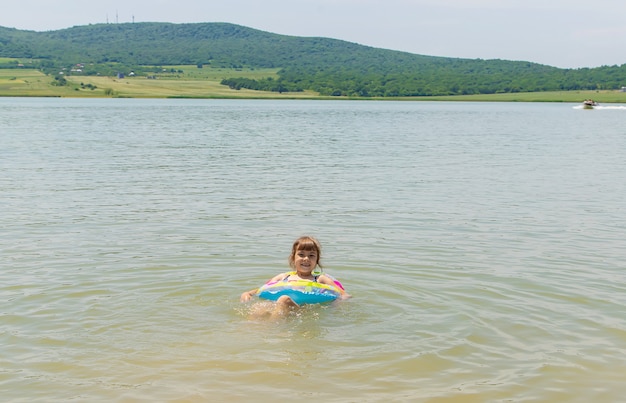 Foto crianças nadando no lago.