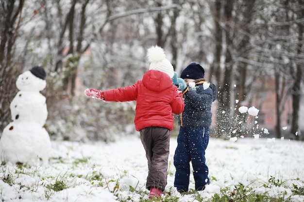 Crianças no parque de inverno brincam