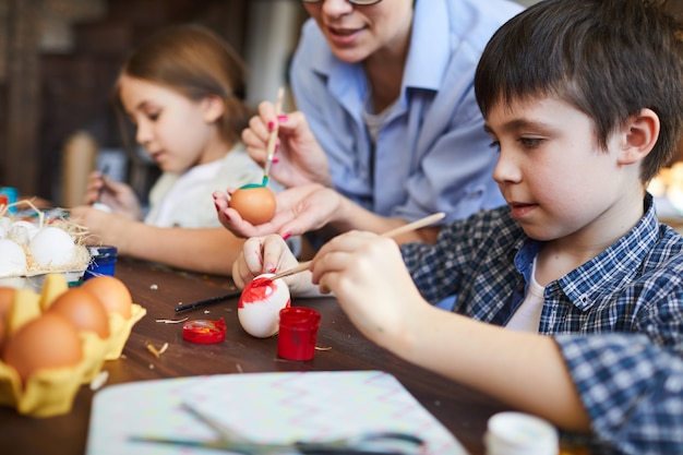 Crianças pintando ovos de páscoa