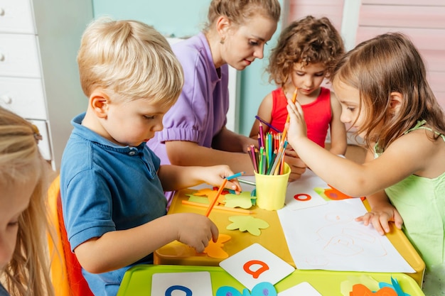 Crianças pré-escolares aprendem o alfabeto inglês usando cartões