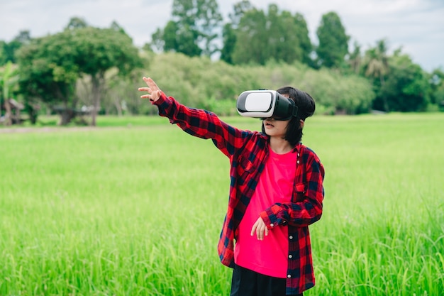 Crianças usando óculos de realidade virtual e alegres com a bela natureza do fundo