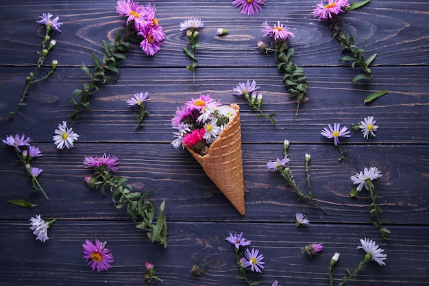 Crisantemos en una copa de helado sobre un fondo azul.