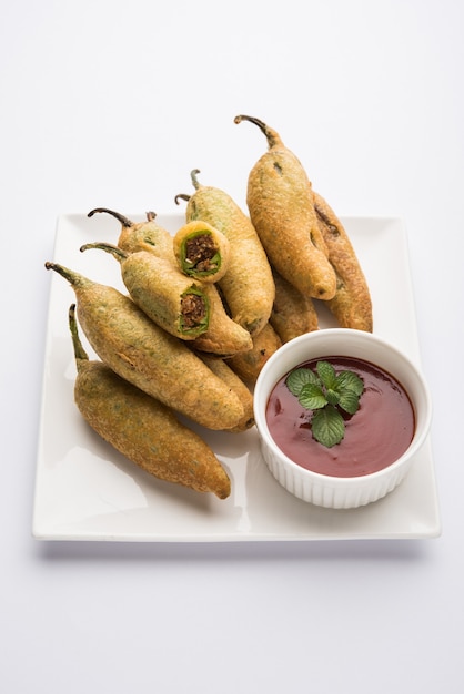 Crispy Green Chilli Pakora o Mirchi Bajji, servido con salsa de tomate. Es un bocadillo popular para la hora del té en la India, especialmente en Monzón. Enfoque selectivo