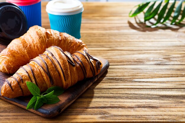 Croissant y café en la mesa de madera