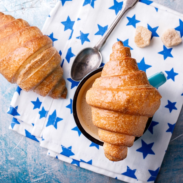 Croissant e café com leite. Cozimento fresco do café da manhã.