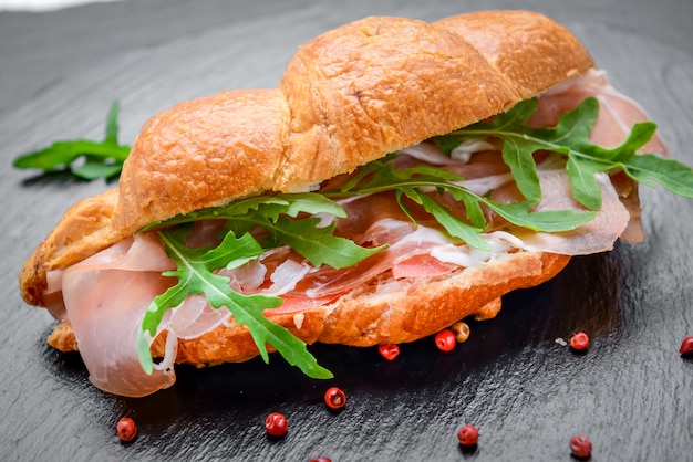 Croissant fresco con jamón y ensalada de hojas