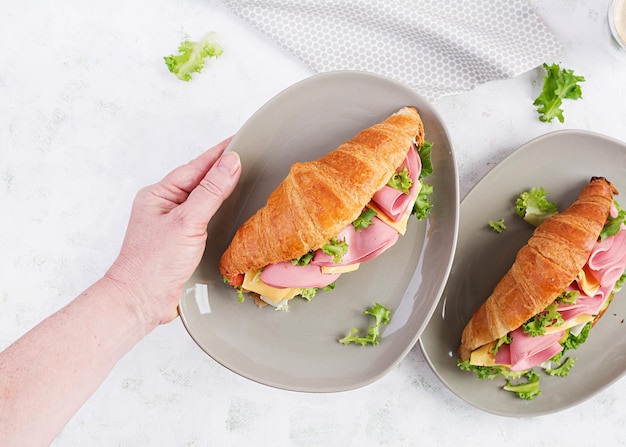 Croissant fresco ou sanduíche com salada de presunto e queijo sobre fundo claro Vista superior