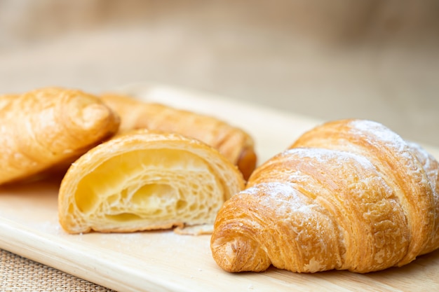 Croissant con glaseado en placa de madera