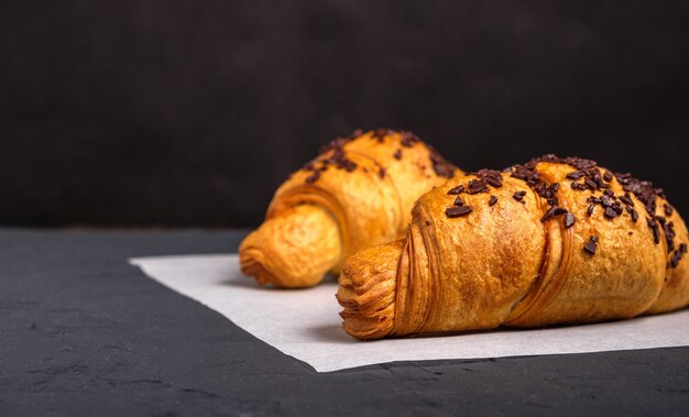 Croissants con chocolate sobre un fondo oscuro