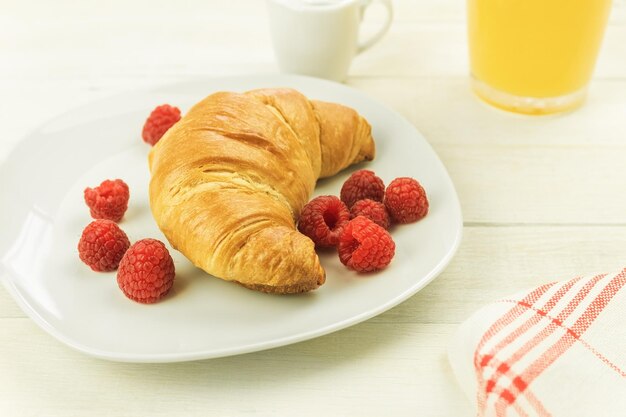 Croissants com café e deliciosas framboesas frescas