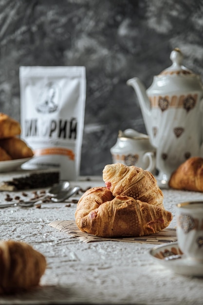 croissants macios frescos estão sobre um fundo de concreto de mesa branca e bolos