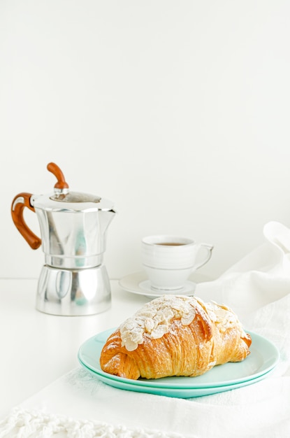 cruasanes y café en mesa blanca