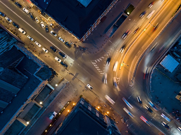 Cruce de carreteras por la tarde o noche con faros de luz y vista aérea de movimiento de automóviles por drones en la ciudad de Kiev Ucrania