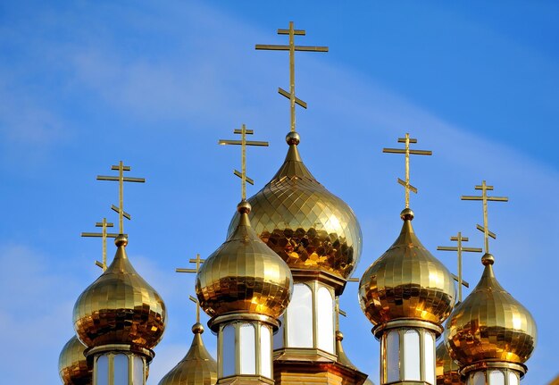 Cruces doradas en las cúpulas de la Iglesia Ortodoxa en Rusia contra el cielo azul en un día soleado