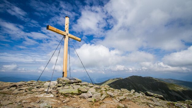 Cruz cumbre de madera en una montaña alpina en austria