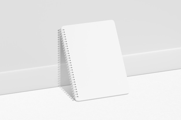 Foto cuaderno blanco sobre una superficie blanca