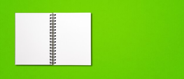 Cuaderno espiral abierto en blanco aislado en banner horizontal verde