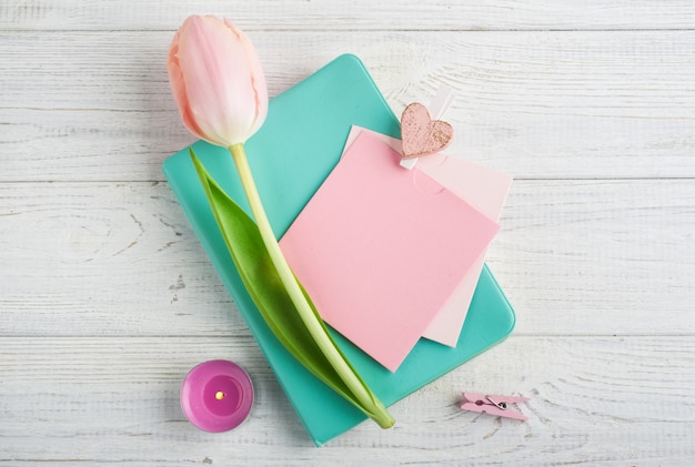 Cuaderno de menta, tulipanes y velas encendidas