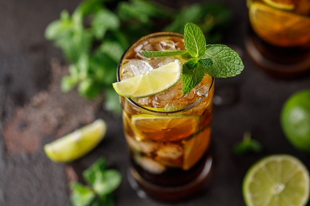 Cuba Libre con ron marrón, cola, menta y lima. Cóctel de té helado Cuba Libre o Long Island con bebidas fuertes