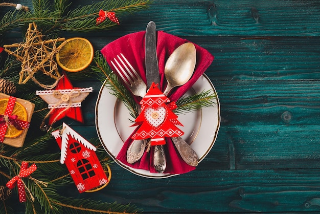 Cubiertos de servir de Navidad con placa sobre un fondo de madera