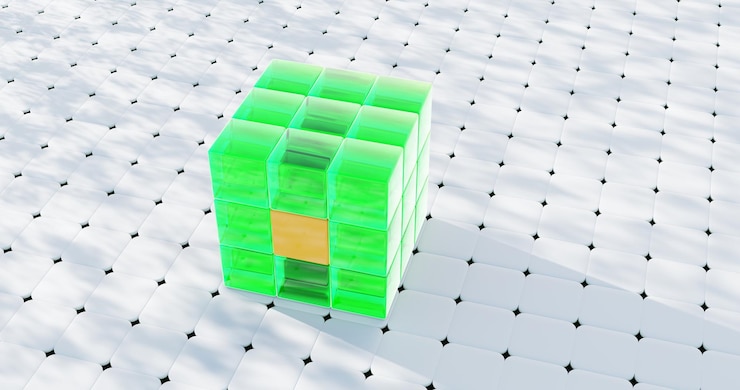 Foto un cubo verde hecho de cubos más pequeños con un componente naranja se encuentra sobre un fondo blanco