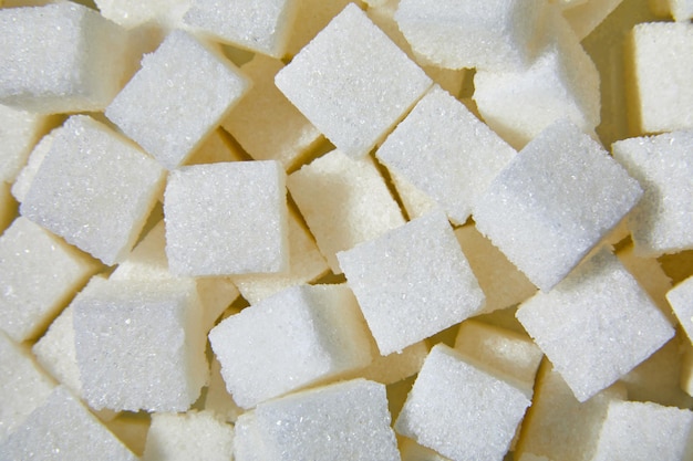 Cubos de azúcar blanco macro laicos planos cerrar fondo de textura