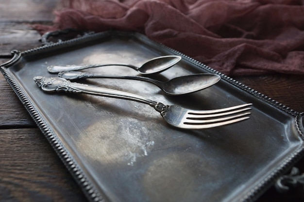 Cucharas de cubiertos de cocina vintage y tenedor en bandeja de plata