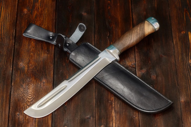 Cuchillo de caza de acero hecho a mano sobre una superficie de madera