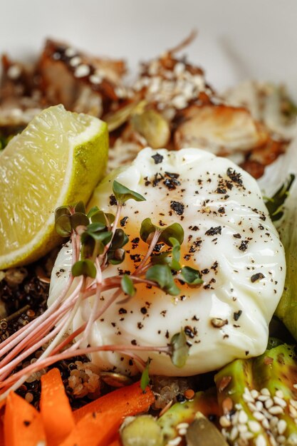 Cuenco saludable: ensalada de quinoa con atún, brócoli, aguacate en una mesa rústica de madera. vista superior.