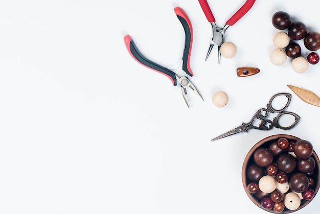 Cuentas de madera y herramientas para la creación de joyería de moda en la manufactura.