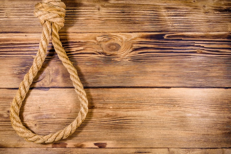 Foto cuerda con soga para el suicidio sobre fondo de madera
