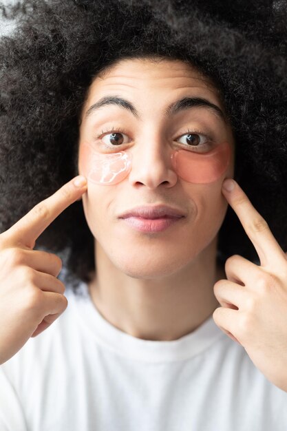 Foto cuidado facial de homem, hidratante de pele, produto cosmético antienvelhecimento, surpreendeu cara bonito com marrom longo