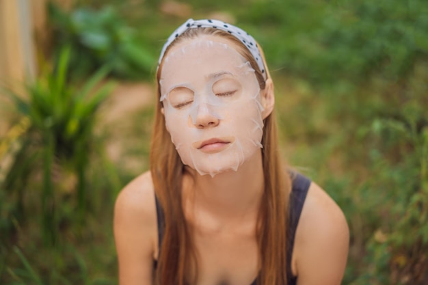 Cuidado facial y tratamientos de belleza Mujer con una mascarilla hidratante de hoja en la cara