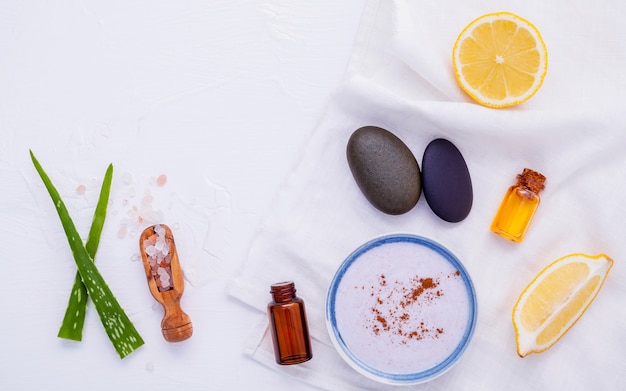 Cuidado de la piel hecho en casa y exfoliante corporal con ingredientes naturales sobre fondo blanco de madera.