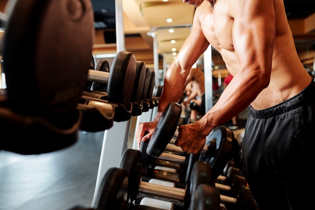 Culturista entrenando con mancuernas