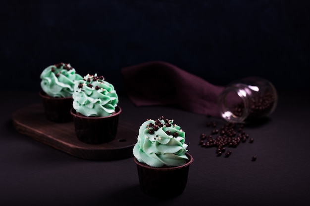 Foto cupcakes e granulado em uma superfície escura