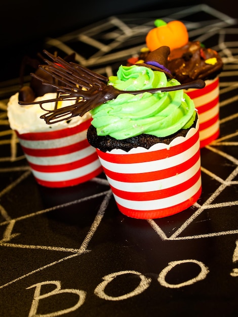 Cupcakes gourmet de Halloween con fondo negro de decoración navideña.