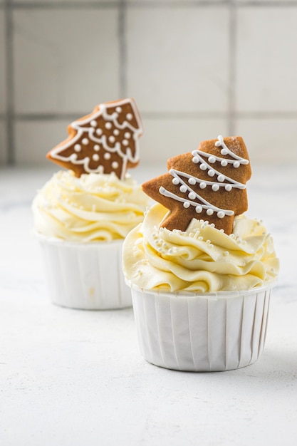 Cupcakes mit Frischkäsecreme und Erdnuss-Karamell-Füllung. Weihnachtsgeschenksets mit Desserts. Kuchen im Neujahrsdekor.