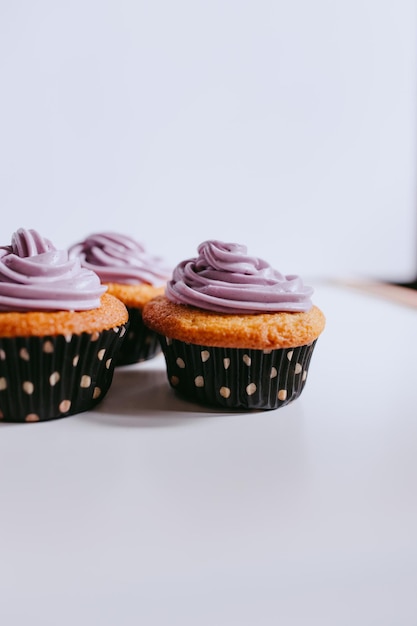 Cupcakes mit lila Zuckerguss auf einem Tisch