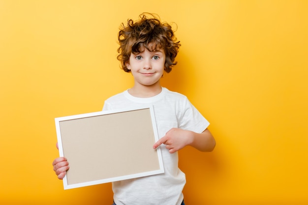 Curly Boy hält einen leeren Rahmen