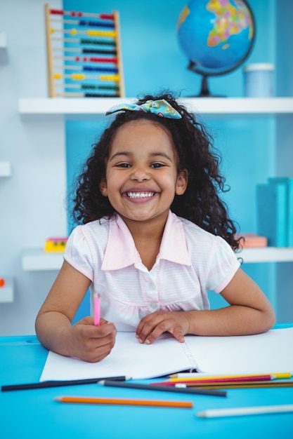 Cute girl drawing on notebook